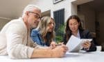 Financial advisor talking to a couple about their options to buy a house